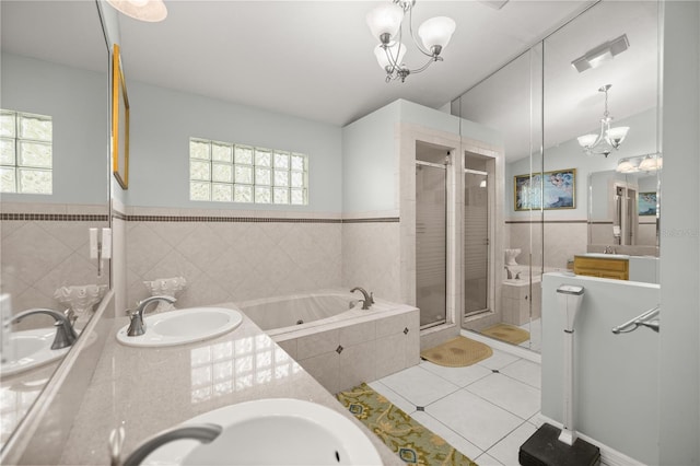 bathroom with visible vents, a shower stall, an inviting chandelier, tile patterned floors, and a sink