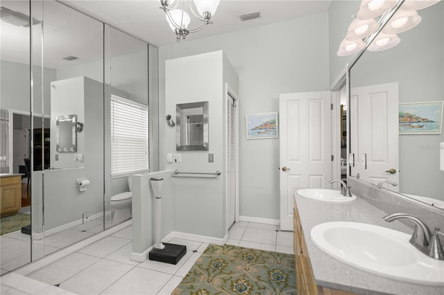 bathroom featuring tile patterned floors, visible vents, a sink, double vanity, and a chandelier