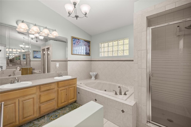 bathroom featuring a sink, a chandelier, and vaulted ceiling