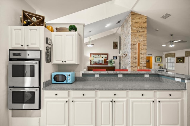 kitchen with double oven, a ceiling fan, visible vents, and vaulted ceiling