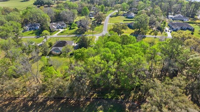 bird's eye view with a wooded view