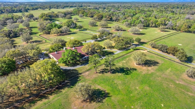 drone / aerial view with a wooded view