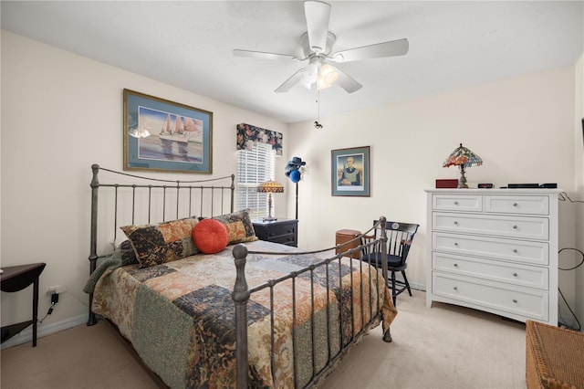 bedroom featuring light carpet, baseboards, and a ceiling fan