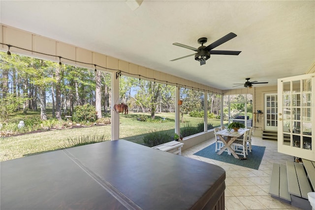 sunroom / solarium featuring ceiling fan