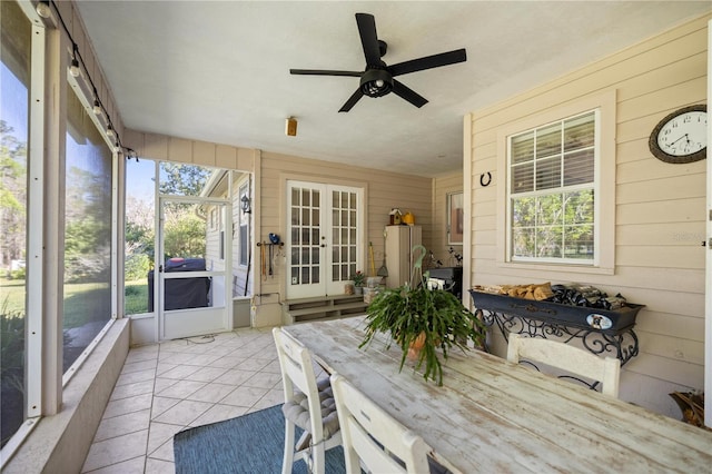 sunroom / solarium featuring french doors and ceiling fan
