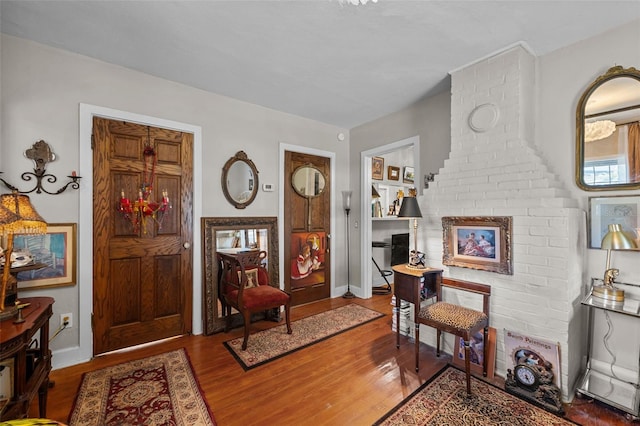 foyer entrance featuring baseboards and wood finished floors