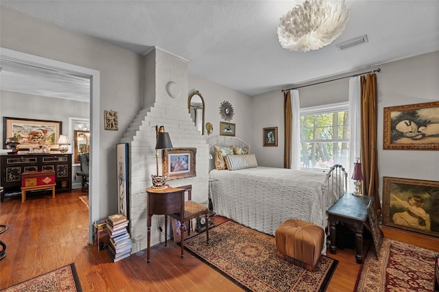 bedroom with wood finished floors and visible vents