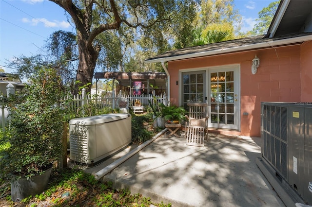 view of patio featuring cooling unit and fence