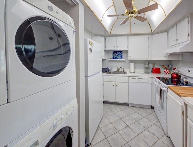 kitchen with a ceiling fan, under cabinet range hood, white appliances, light countertops, and stacked washer / dryer