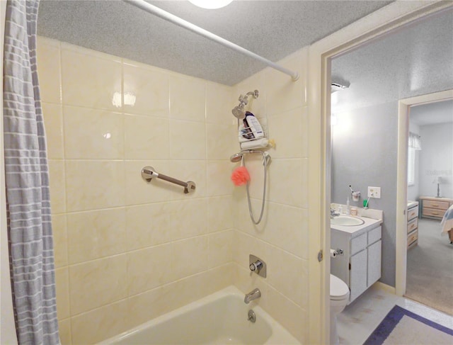 full bath with vanity, a textured ceiling, shower / tub combo with curtain, and toilet