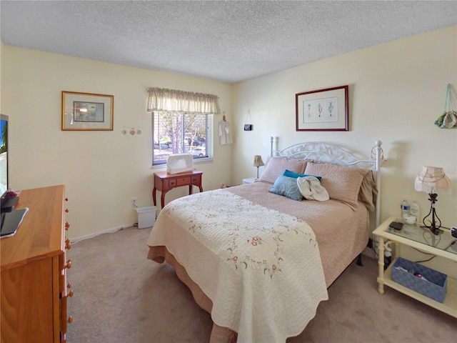 bedroom featuring carpet and a textured ceiling