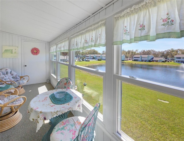 unfurnished sunroom with a water view and vaulted ceiling