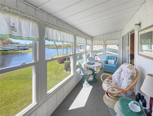 sunroom / solarium with vaulted ceiling and a water view