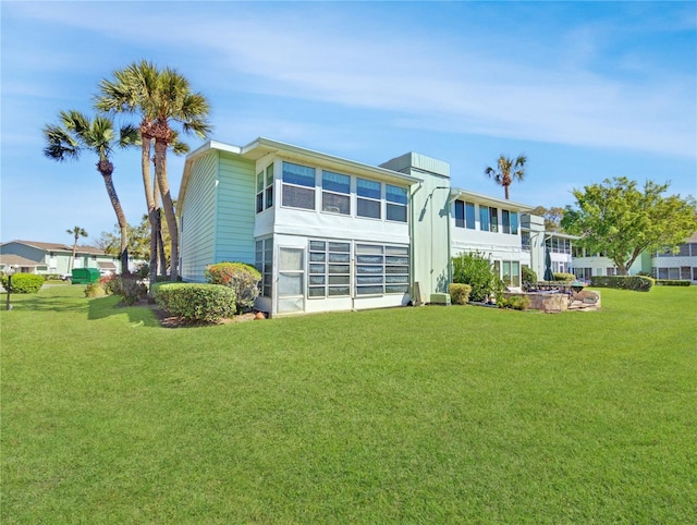 rear view of property with a yard