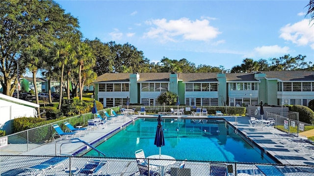 community pool featuring a patio area and fence