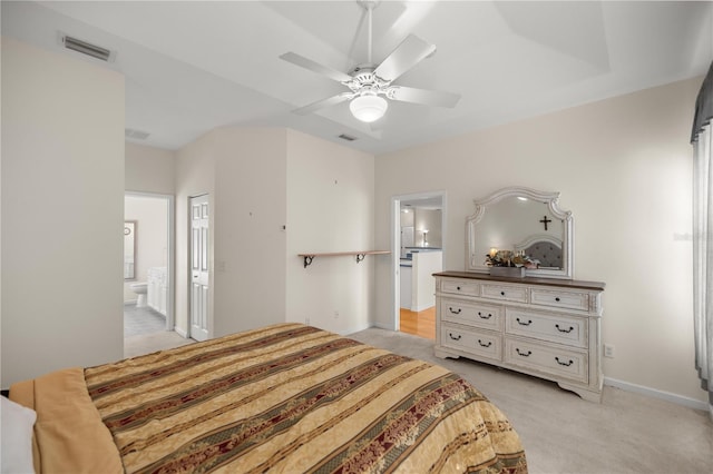 bedroom with visible vents, baseboards, ensuite bath, ceiling fan, and light colored carpet