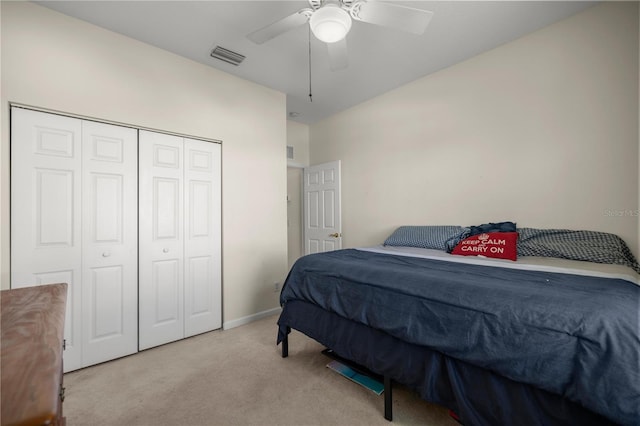 bedroom with baseboards, visible vents, carpet floors, ceiling fan, and a closet