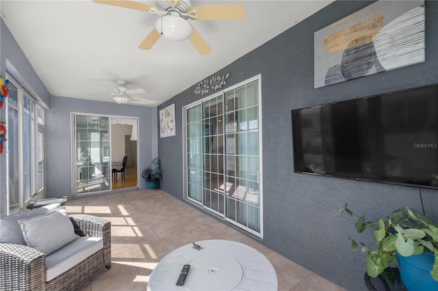 sunroom featuring ceiling fan