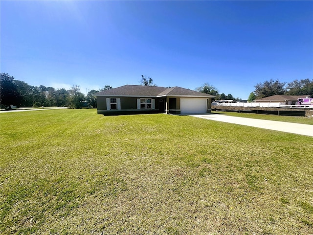 view of front of home featuring a garage, concrete driveway, and a front lawn