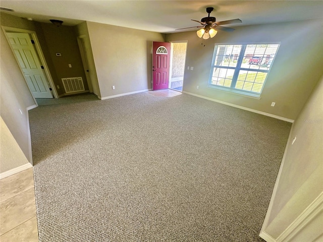 spare room featuring light colored carpet, baseboards, and visible vents