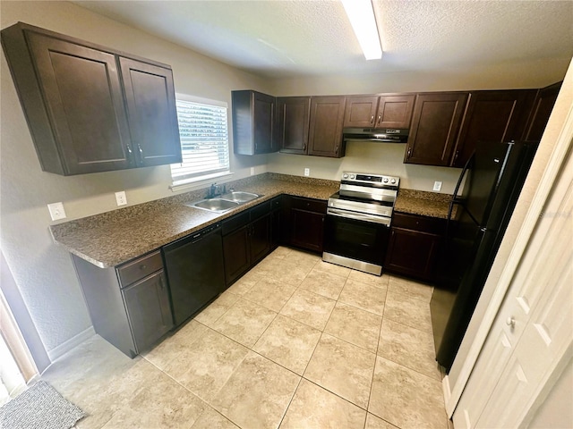 kitchen with black appliances, a sink, under cabinet range hood, dark countertops, and a textured ceiling