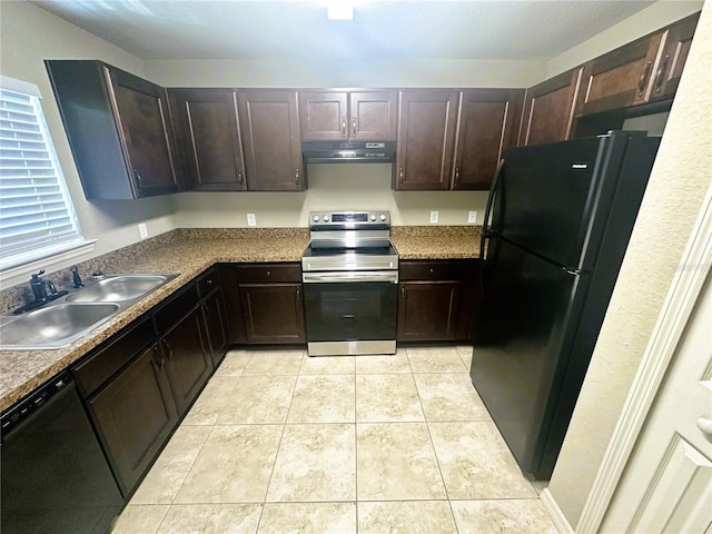 kitchen featuring black appliances, under cabinet range hood, a sink, dark brown cabinetry, and light tile patterned floors