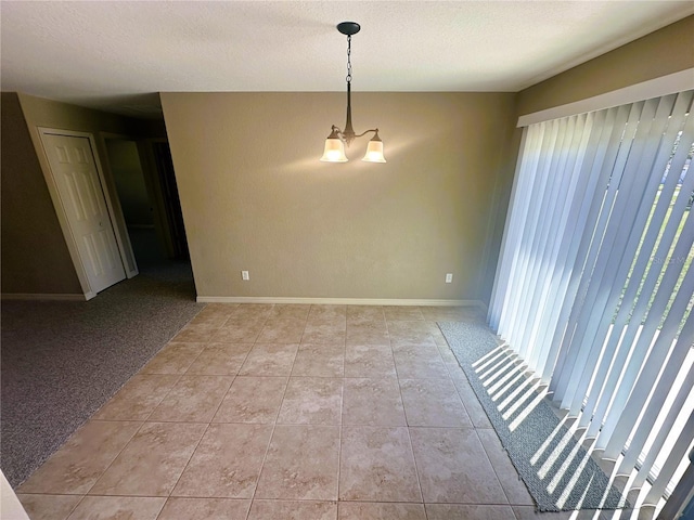 unfurnished room with light tile patterned floors, baseboards, a textured ceiling, and a chandelier