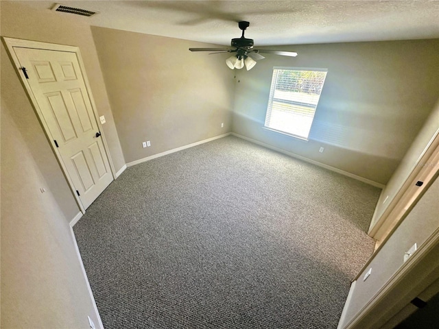 carpeted empty room with visible vents, baseboards, a textured ceiling, and a ceiling fan