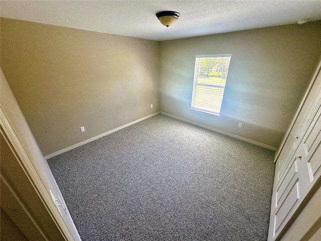 unfurnished bedroom with baseboards and carpet floors