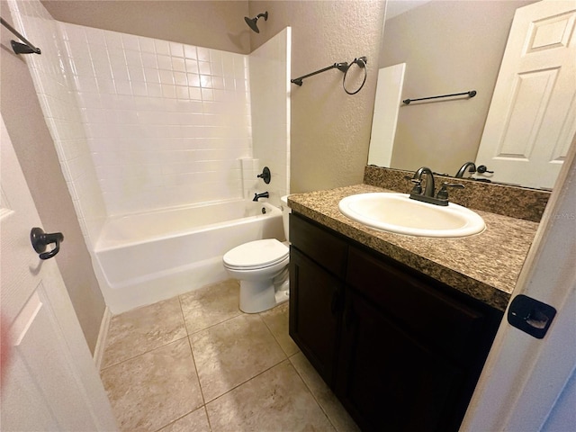 bathroom with tile patterned flooring, toilet, bathing tub / shower combination, a textured wall, and vanity