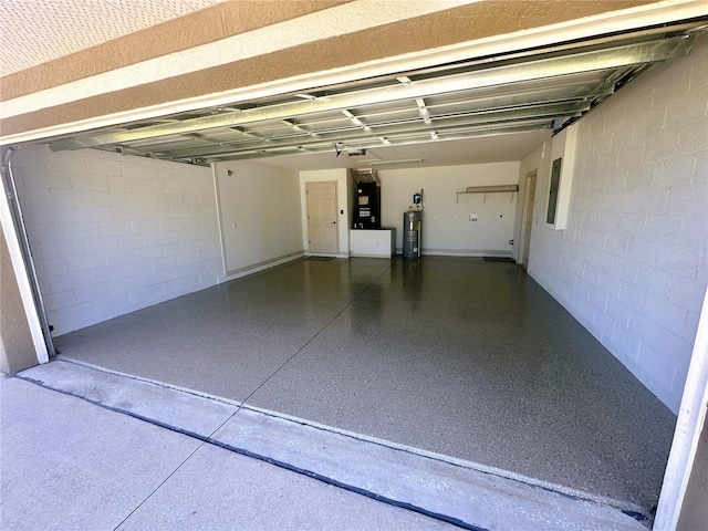 garage featuring electric panel, heating unit, electric water heater, and concrete block wall