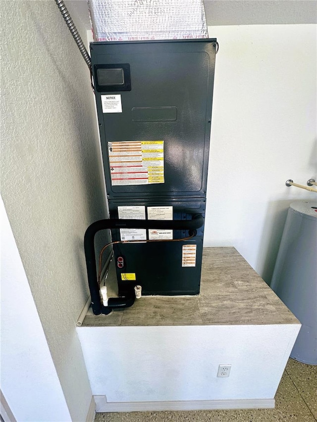 utility room featuring heating unit