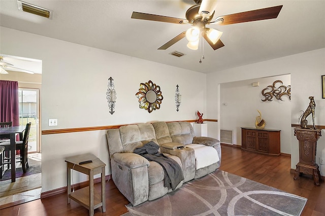 living area featuring ceiling fan, visible vents, and wood finished floors