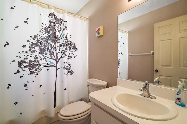 bathroom with vanity, curtained shower, and toilet