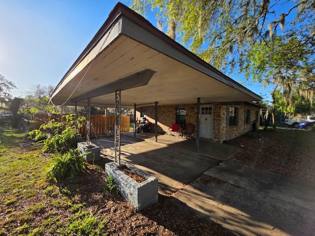 back of property featuring brick siding, a patio, and fence