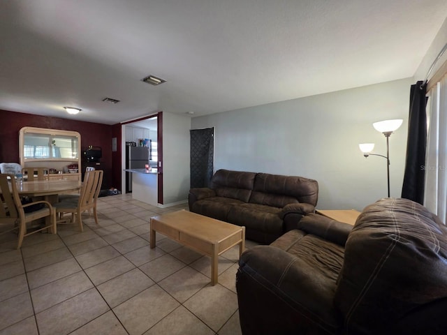 living room with visible vents and light tile patterned flooring