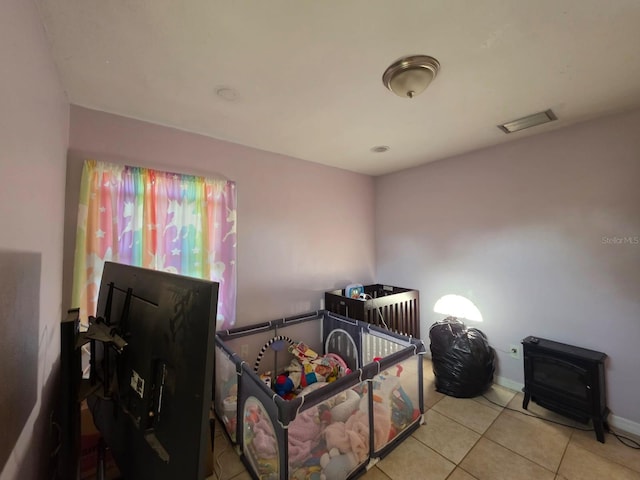 bedroom featuring tile patterned flooring, baseboards, and visible vents