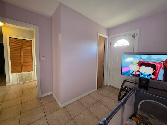 foyer with light tile patterned flooring, visible vents, and baseboards