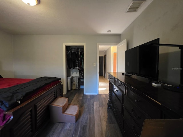 bedroom featuring a closet, visible vents, and wood finished floors