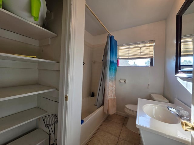 full bath featuring tile patterned floors, shower / bath combo with shower curtain, toilet, and plenty of natural light