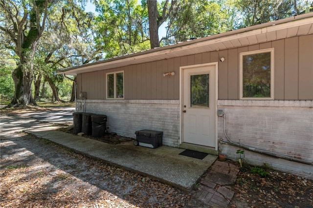 entrance to property with brick siding