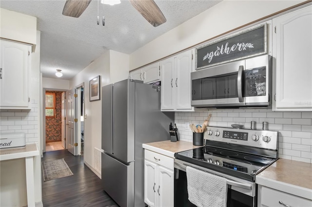 kitchen featuring white cabinets, dark wood-style floors, and stainless steel appliances