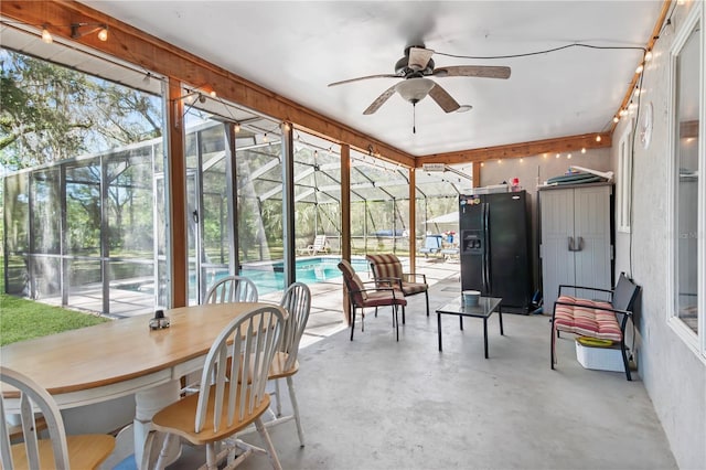 sunroom / solarium featuring ceiling fan