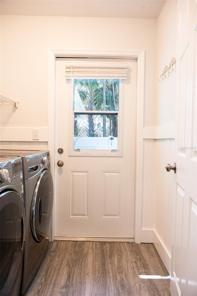 washroom featuring laundry area, wood finished floors, and separate washer and dryer