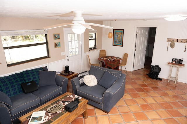 living room with light tile patterned floors and a ceiling fan