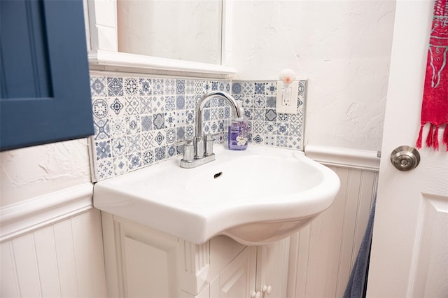 bathroom with a sink and a wainscoted wall