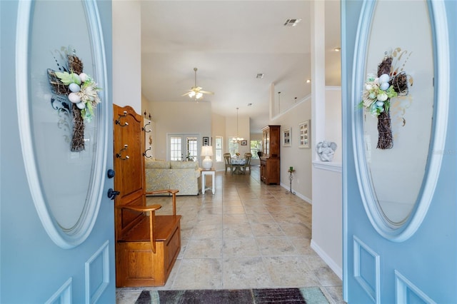 foyer featuring visible vents, baseboards, and ceiling fan