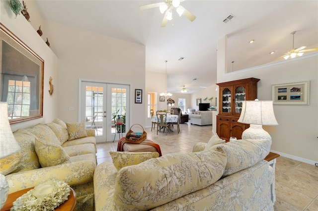 living room featuring a wealth of natural light, visible vents, french doors, and a ceiling fan