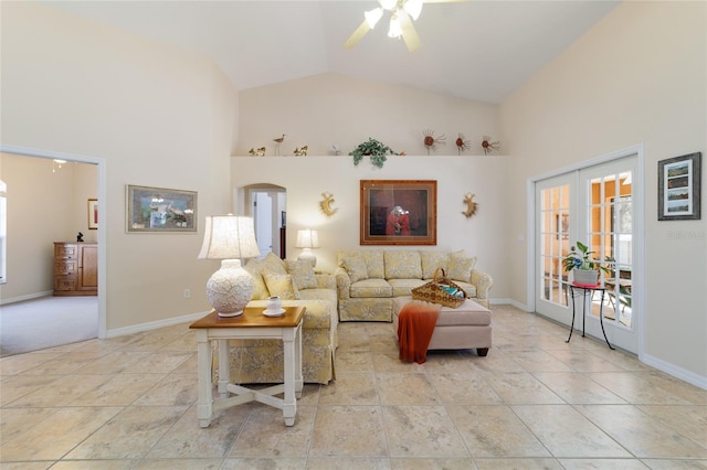 living area with a ceiling fan, baseboards, and high vaulted ceiling