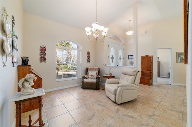 living area featuring high vaulted ceiling, light tile patterned floors, baseboards, and a chandelier